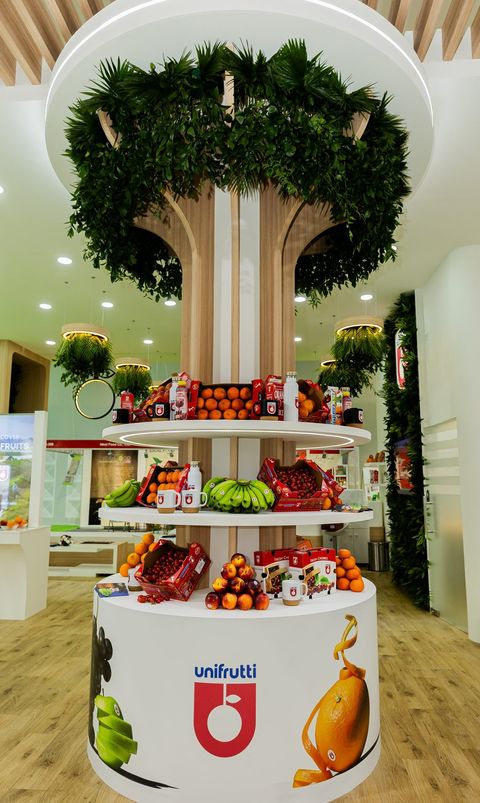 Unifrutti exhibition stand, with a living tree rising from a display of fresh fruit